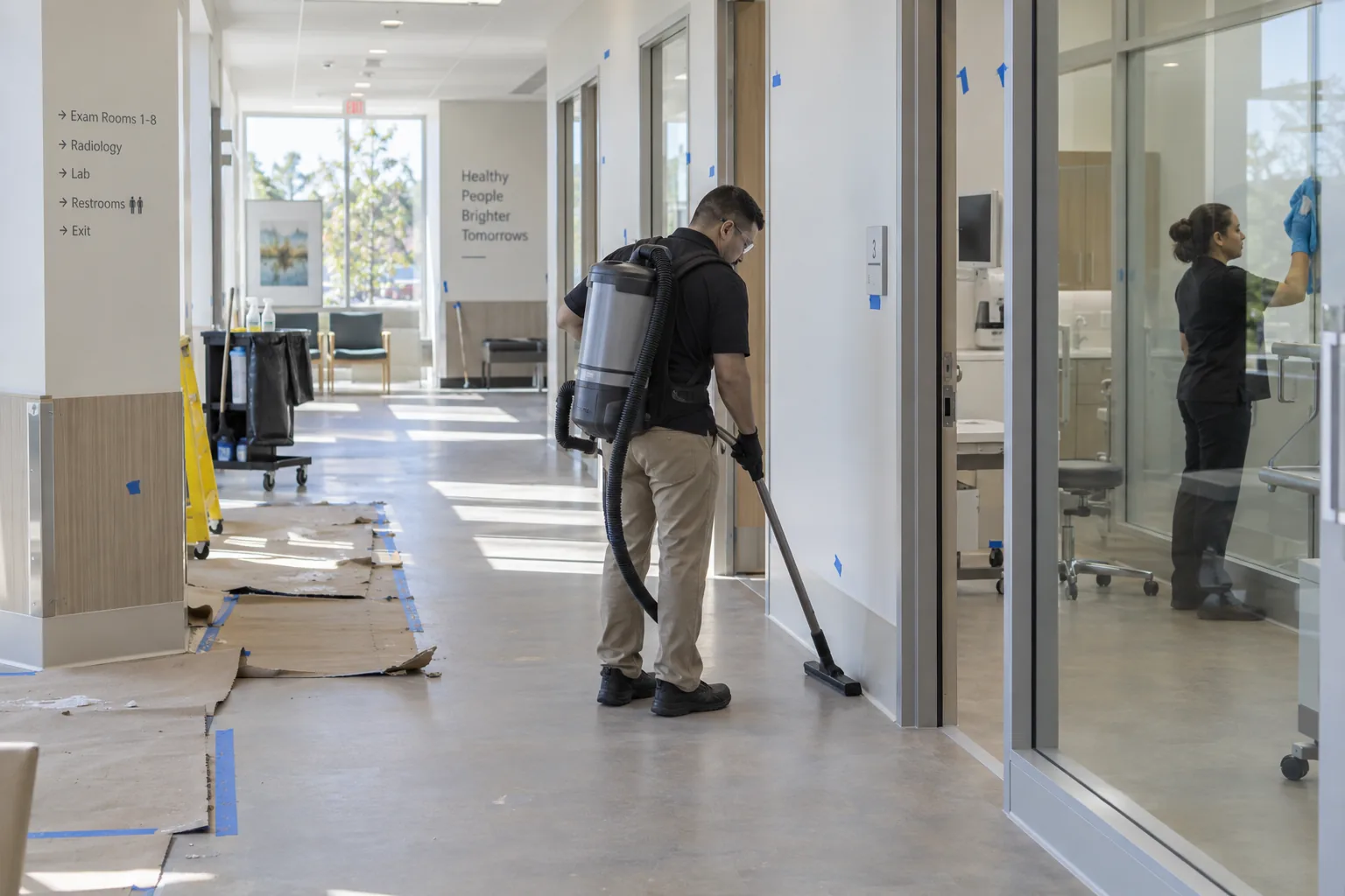 Commercial cleaning technicians completing a final clean in a newly built clinic